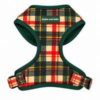 A dog harness with a red, yellow, and beige plaid pattern and dark green trim, featuring a green brand label that reads 'Pipkin and Bella'.